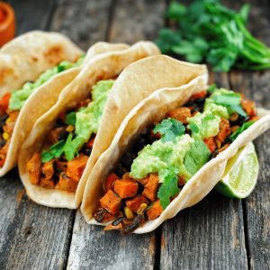 Plant-based tacos topped with guacamole. 