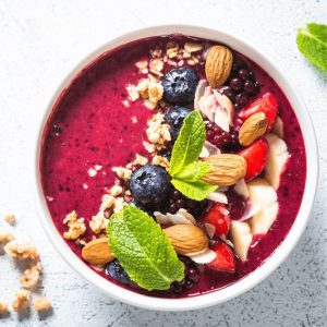 Hibiscus Smoothie Bowl topped with fruit nuts. 