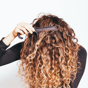 Combing curly hair. Inversion method.