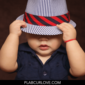 Baby boy wearing hat.