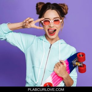 Girl with double bun hairstyle, and skateboard. Fun hairstyle for curly haired girls. 